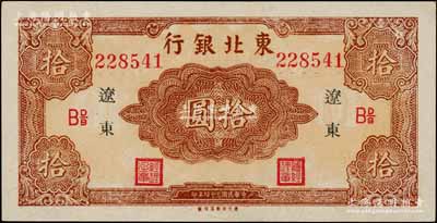 民国三十四年（1945年）东北银行红色拾圆长号券，辽东地名，下边有“东方印刷局印制”厂铭，且票内有英文水印；资深藏家出品，上佳品相，九八成新